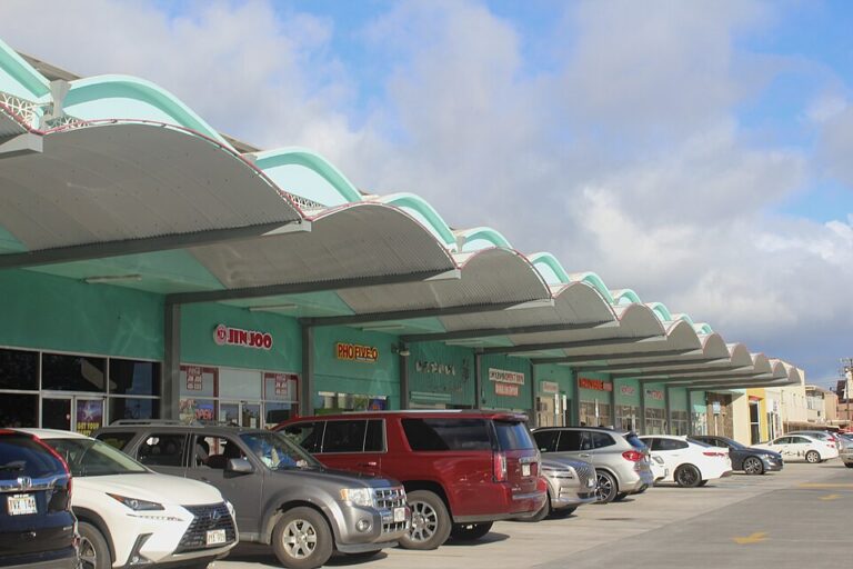 Waimalu Shopping Center storefronts and parking area in 2021